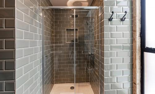 a shower with a glass door in a bathroom at The Sanctuary in Stow on the Wold