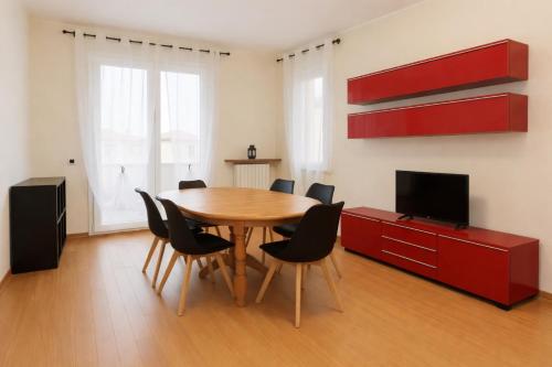 a dining room with a wooden table and chairs at Orio Relax&Fly in Grassobbio