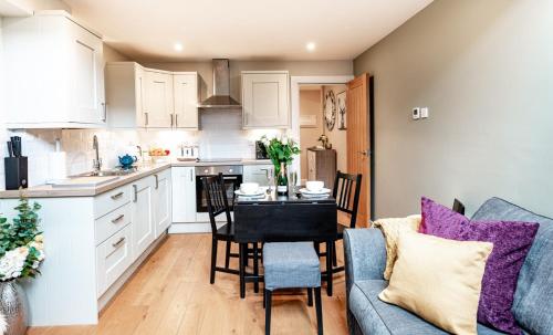 a kitchen and living room with a table and chairs at The Sanctuary in Stow on the Wold