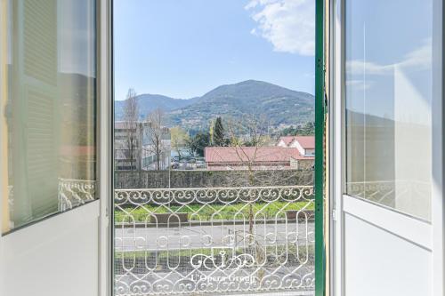 a window with a view of a mountain at Vestamonti Apartment in La Spezia