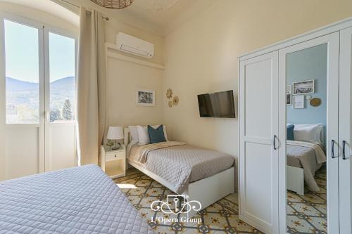 a bedroom with two beds and a sliding glass door at Vestamonti Apartment in La Spezia