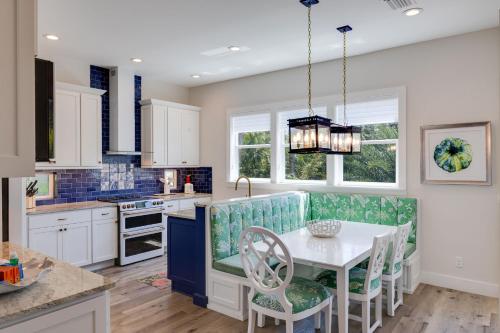 a kitchen with a white table and chairs at Sea U Soon - Premier 4 Bedroom Villa with Heated Pool in Captiva