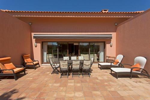 a patio with a bunch of chairs and a table at GuestReady - Tranquillity in Baião in Baião