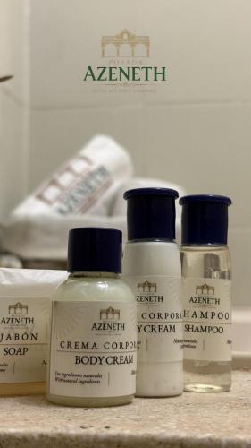 a group of four bottles of hair products on a counter at Posada Azeneth in Oxkutzcab