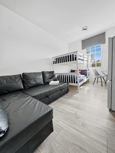 a living room with a couch and a bunk bed at Family Rooms for 6 in Zone 2 - Willesden Green in London