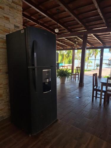 a black refrigerator in a room with a table at Casita Maya Bacalar in Bacalar