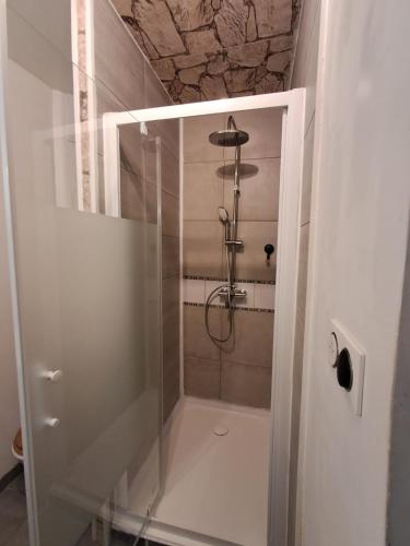 a shower with a glass door in a bathroom at Locmeze in Mèze