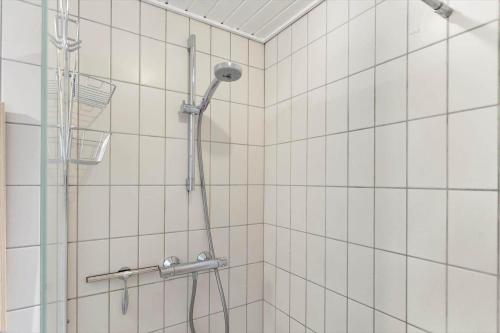 a shower in a bathroom with white tiled walls at AE318-Marstal-Faergestraede-45 in Marstal