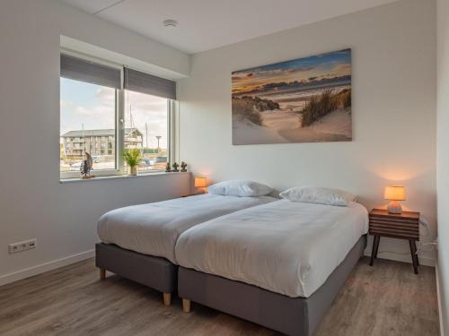a bedroom with a bed and a large window at Het Havenverblijf in Kamperland