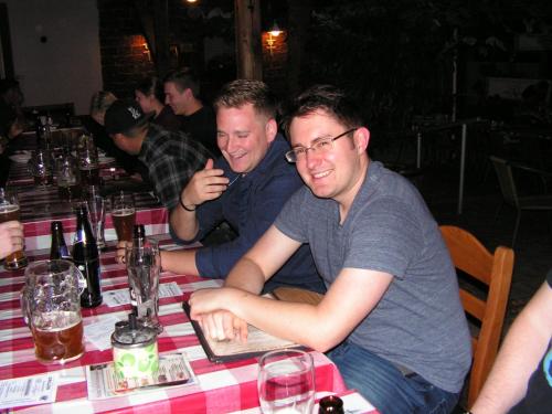 two men sitting at a table with a laptop at Bauer Schmidt Weilerbach Bauer`s Budget-Hotel in Weilerbach