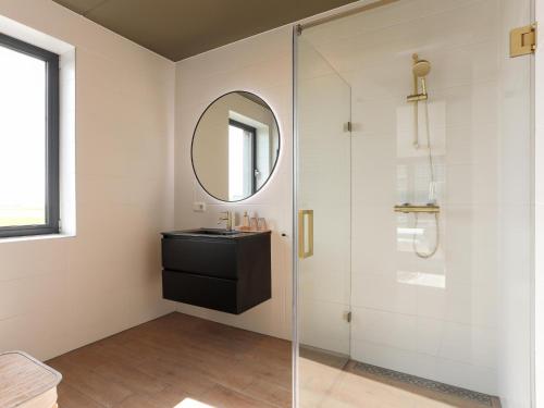 a bathroom with a sink and a glass shower at Marina Vista in Kamperland