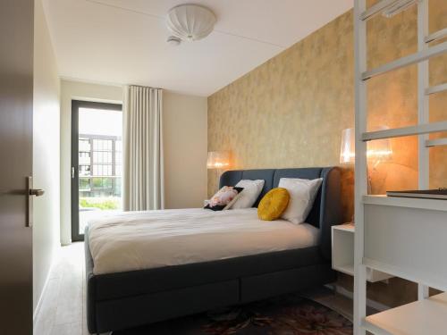 a bedroom with a bed with a blue head board at Marina Vista in Kamperland