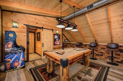 a game room with a pool table in a cabin at Makin' Memories cabin in Sevierville