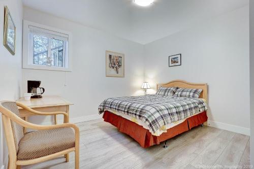 a bedroom with a bed and a desk and a chair at Quiet Suites Up to 8 Guests Near DTVan Monthly Option in West Vancouver
