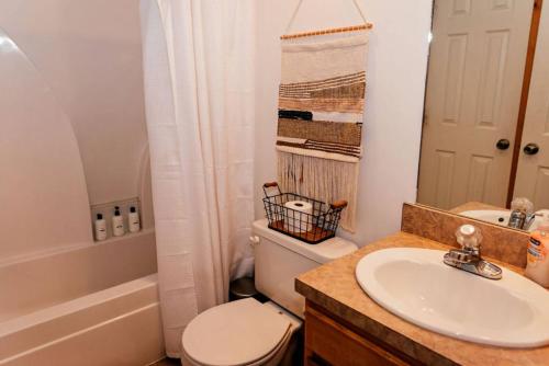a bathroom with a white toilet and a sink at A Blind Camelback Mtn views 2m to slopes in Tannersville
