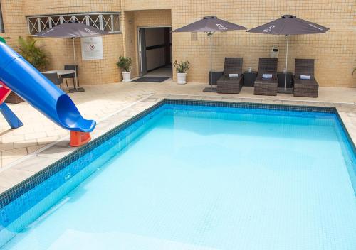a swimming pool with a slide in a hotel at Riale Imperial Flamengo in Rio de Janeiro