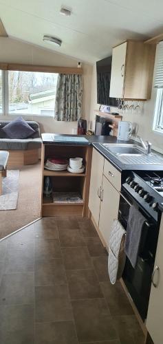 a kitchen with a sink and a stove top oven at Rockley Park, Poole, 3 Bedroom Family Retreat in Poole in Poole