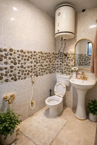 a bathroom with a toilet and a sink at Lake side stays in Srinagar