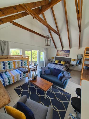 a living room with a blue couch and a table at Cape Dutch Flair in Durbanville