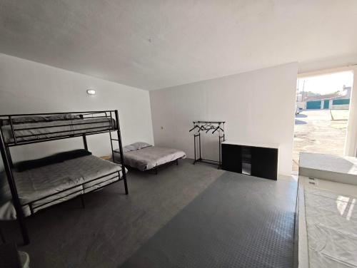 a room with two bunk beds and a window at GuestHouse Relax & Pool in Esmoriz