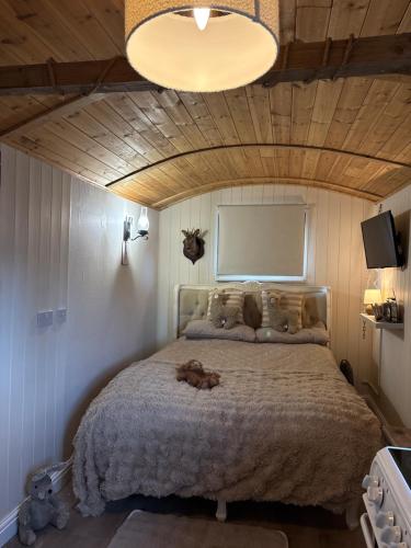 a bedroom with a large bed in a room at Four Seasons Mini Zoo Country Retreat with Wood Fuel Hot Tub close to kington Market Town in Hereford