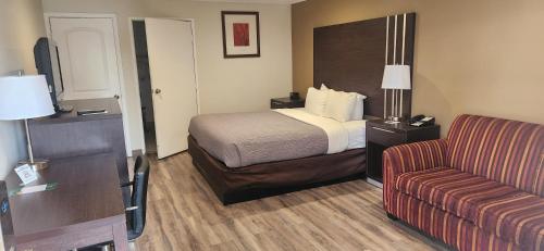 a hotel room with a bed and a couch at Quality Inn Long Beach - Signal Hill in Long Beach