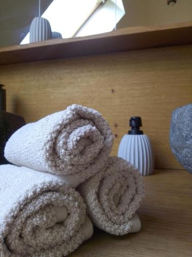 a pile of towels sitting on a shelf at Kleine FeWo, Einstiegspreis! in Weimar