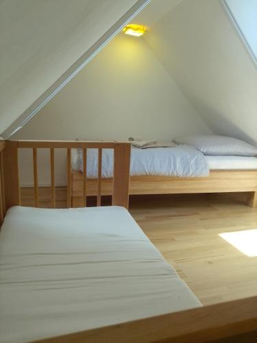 a attic bedroom with a bed and a light at Kleine FeWo, Einstiegspreis! in Weimar