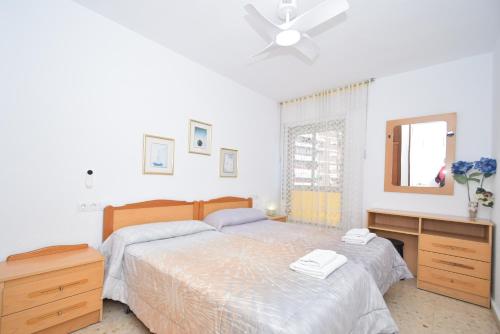 a bedroom with a bed and a ceiling fan at ADELFAS - Fincas Arena in Benidorm