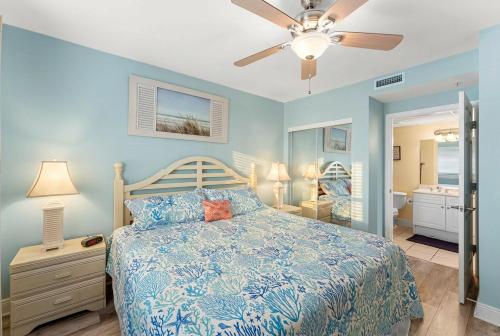 a bedroom with a bed and a ceiling fan at Goin Coastal Emerald Beach Unit 729 in Panama City Beach