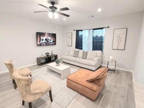 a living room with a couch and a chair at Brand-new home close to LSU campus in Baton Rouge