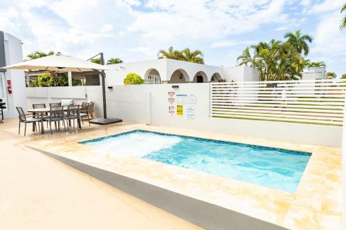 a swimming pool in the backyard of a house at AQUA Casa A-8 - Vibrant & FUN 3 BR House with Pool in Dorado