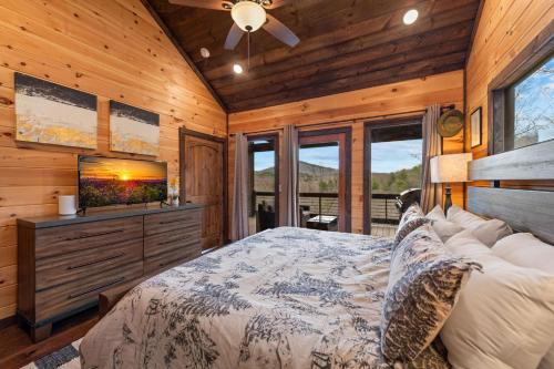 a bedroom with a bed and a flat screen tv at 249 Ranger Station in Morganton
