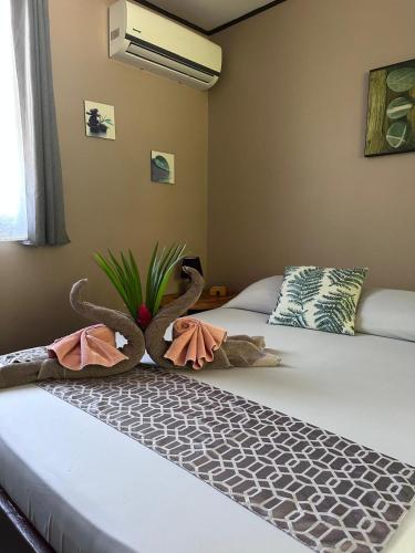a bedroom with a bed with two towels on it at Hotel El Colibri Rojo - Le Colibri Rouge in Cahuita