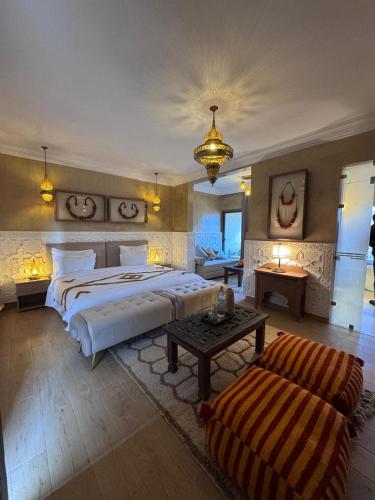 a large bedroom with two beds and a table at Ksar Sultan Dades - Dades Valley Retreat in Boumalne Dades