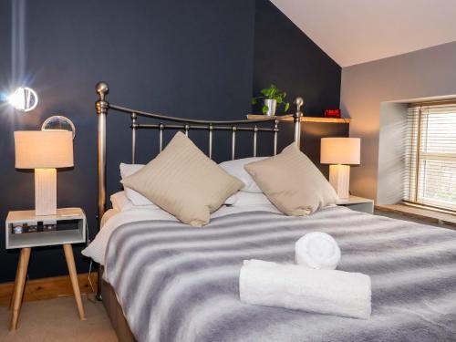 a bedroom with a large bed with two lamps at The Green in Ripon