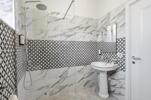 a bathroom with a sink and a shower at Hotel Giulia in Durrës