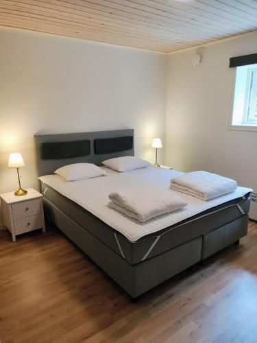 a bedroom with a large bed with two pillows at Lägenhet Bolum 7 in Broddetorp