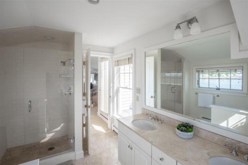 a bathroom with two sinks and a large mirror at Mother`s Beach House in Kennebunk