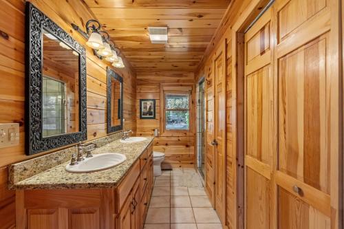 a bathroom with two sinks and a mirror at Johnny's Lakeside Hideaway in Morganton
