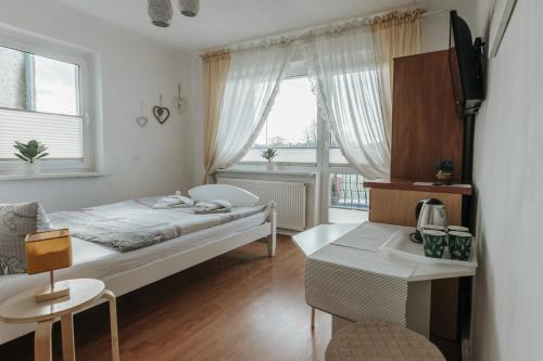 a small bedroom with a bed and a window at Willa Sarenka in Międzyzdroje