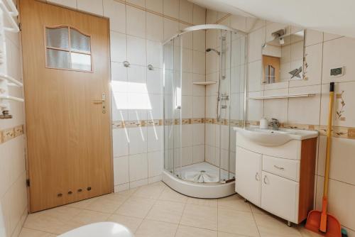 a bathroom with a shower and a sink and a toilet at Willa Sarenka in Międzyzdroje