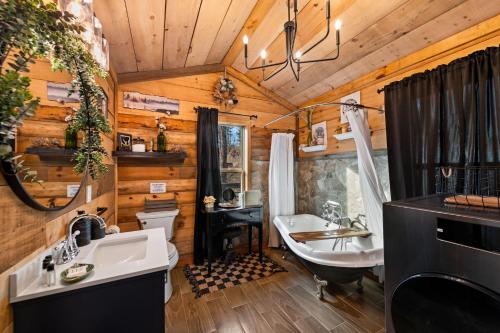 a bathroom with two sinks and a tub and a sink at Bigfoot's Hideout in Blue Ridge