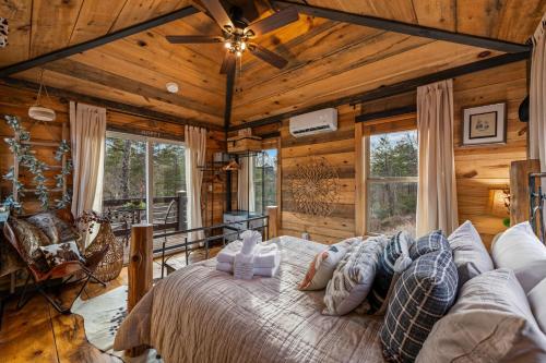 a bedroom with a large bed in a room with wooden walls at Bigfoot's Hideout in Blue Ridge
