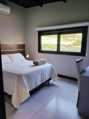 a bedroom with a large bed and a window at Casa do Bem Estar Picada Café in Picada Cafe