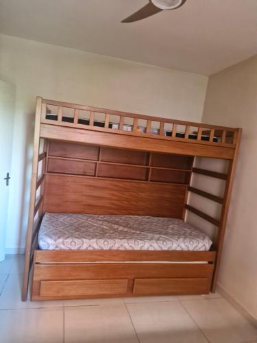 two bunk beds in a room with a ceiling at Apto novo com ampla sacada e piscinas in Guarujá