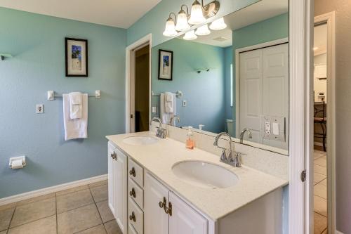 a bathroom with two sinks and a mirror at Saltwater Pool! Sebring Oasis Near Lake Jackson in Sebring