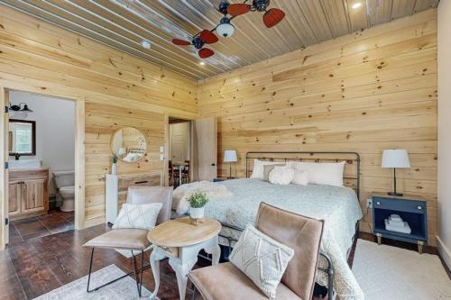 a bedroom with a bed and a wooden wall at Valley Vista Vacay in Littleton