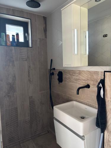 a bathroom with a sink and a mirror at Trinity in Balatonalmádi
