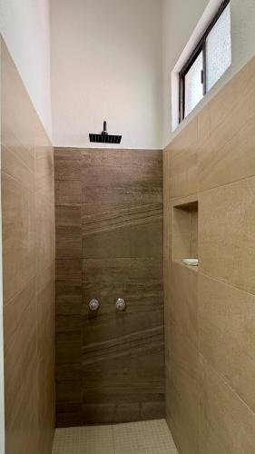 a bathroom with a shower with wooden walls at Star Department We bill in La Paz